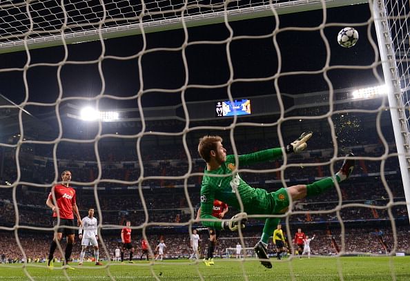 MADRID, SPAIN - FEBRUARY 13: David De Gea of Manchester United makes a save with his foot during the UEFA Champions League Round of 16 first leg match between Real Madrid and Manchester United